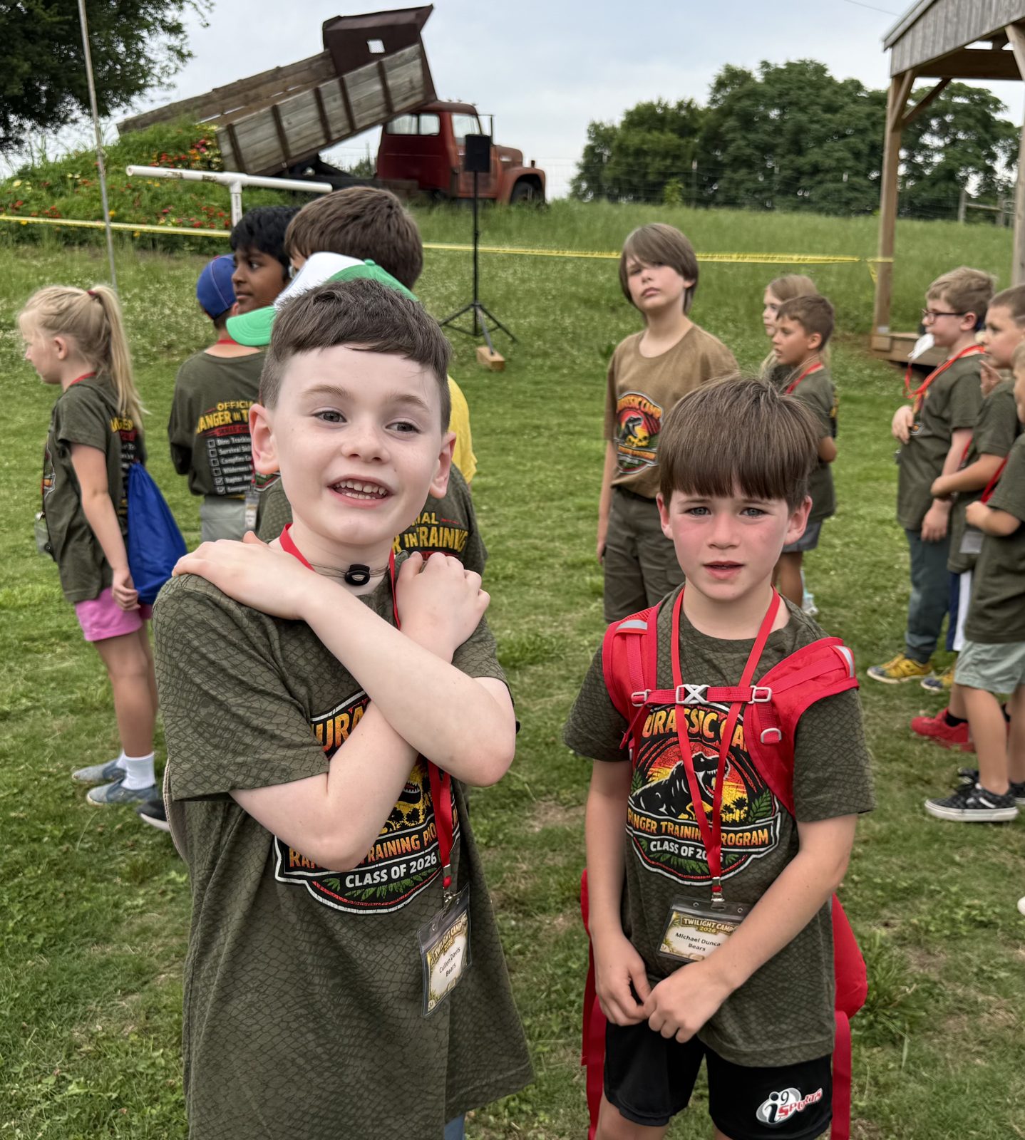 Scouts gathered outdoors wearing camp shirts
